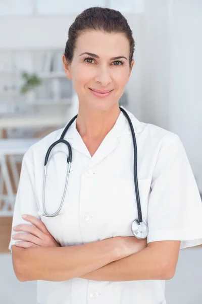 Smiling doctor with arms crossed