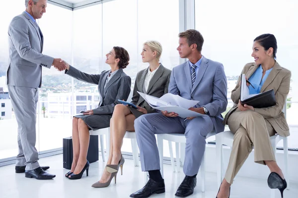 Business people waiting to be called into interview