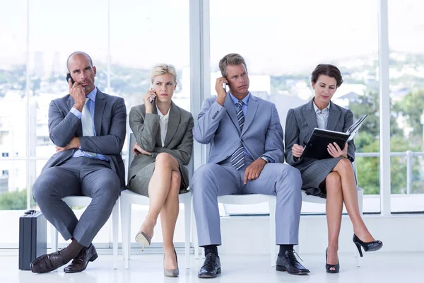 Business people waiting to be called into interview