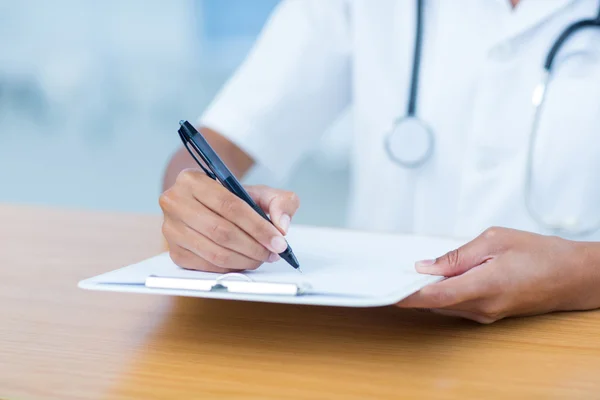 Doctor holding clipboard with file