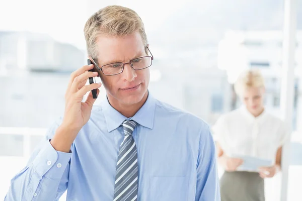 Businessman having a phone call with colleague