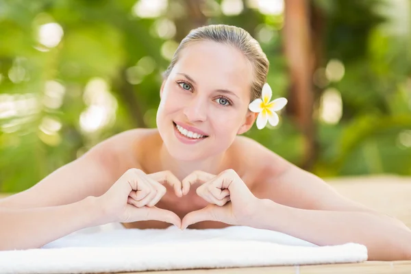 Blonde lying on towel at health spa