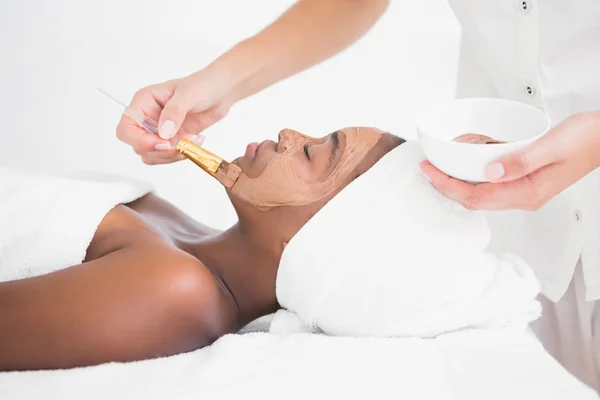 Woman getting chocolate facial treatment