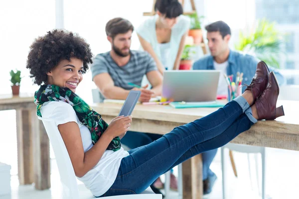 Young casual woman with feet on the table