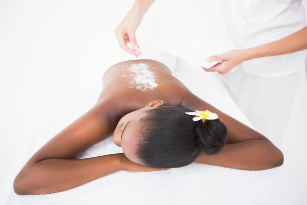 Woman enjoying an exfoliation massage