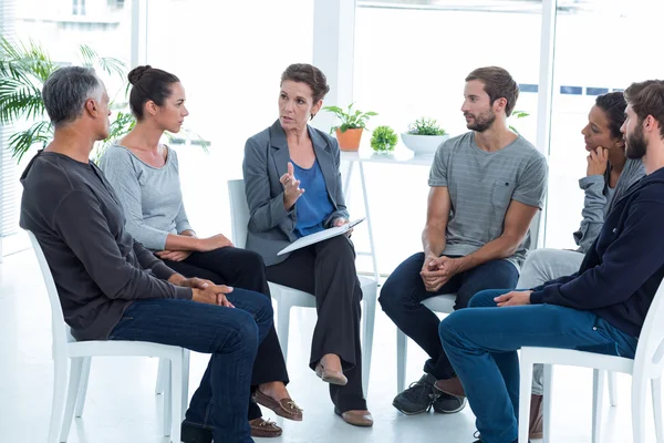 Group therapy in session sitting in a circle