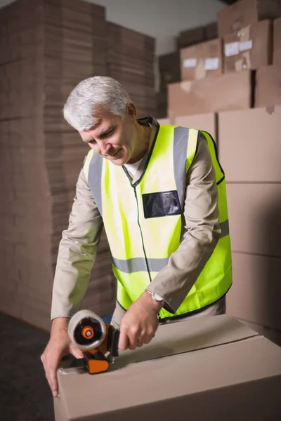 Worker preparing goods for dispatch