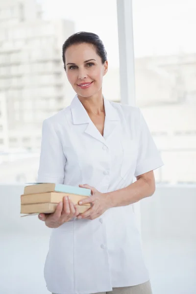 Doctor holding medical books