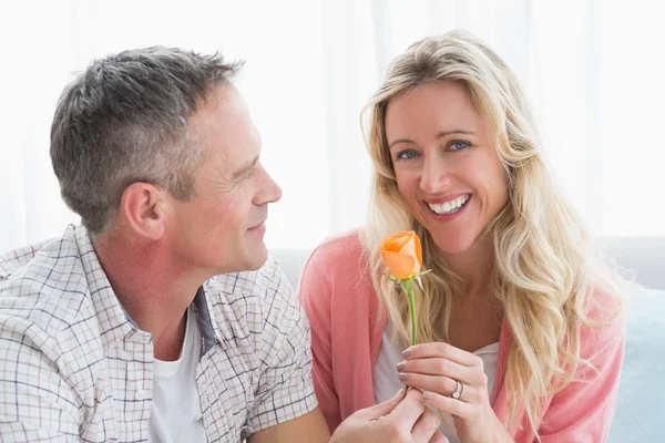 Man offering rose woman