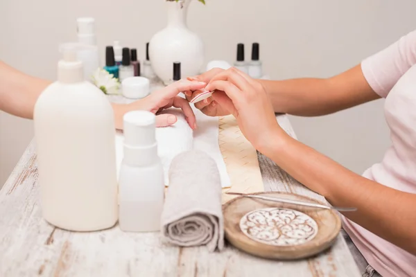 Nail technician giving custome manicure