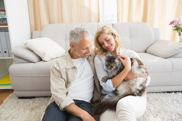 Couple with cat on sofa