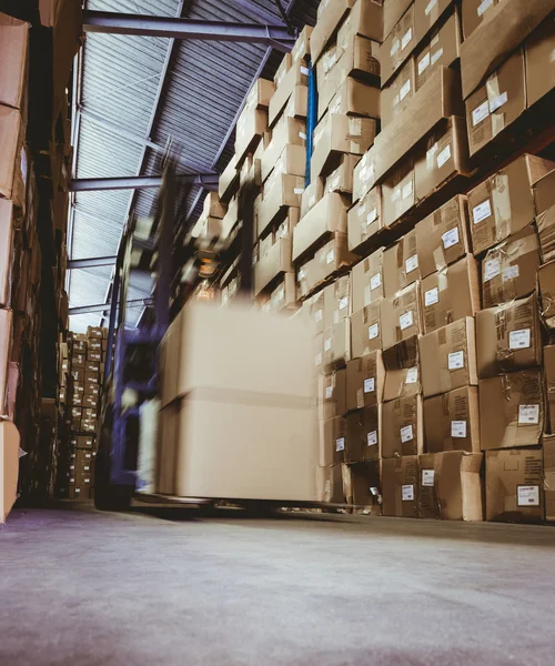 Forklift in large warehouse