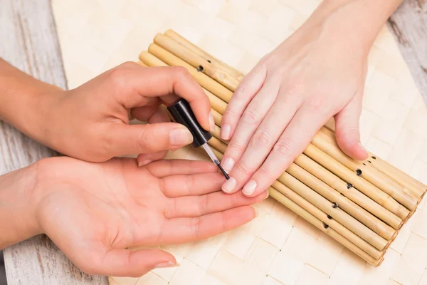 Nail technician giving custome manicure