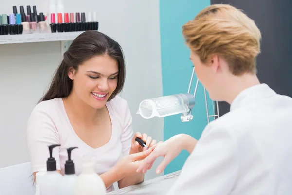 Nail technician giving manicure