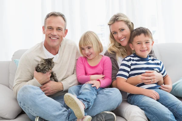 Family sitting with pet kitten