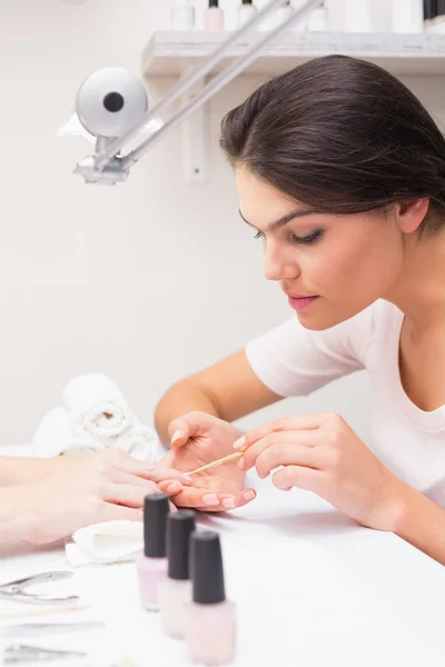 Nail technician giving manicure