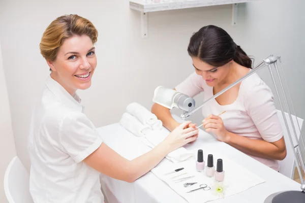 Nail technician giving manicure