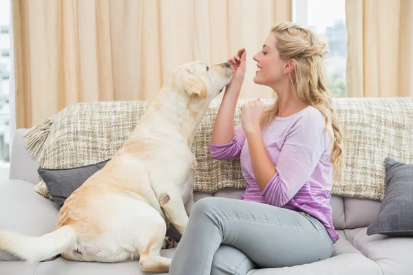 Woman on couch with pet dog