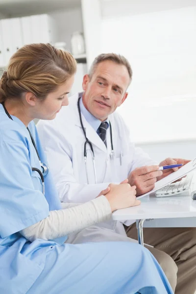 Doctor and nurse looking at computer