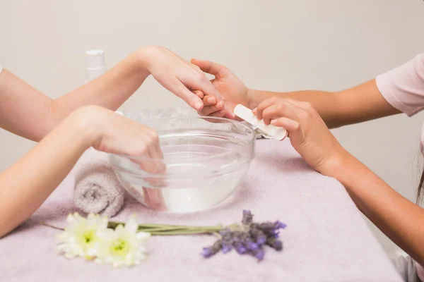 Nail technician giving custome manicure