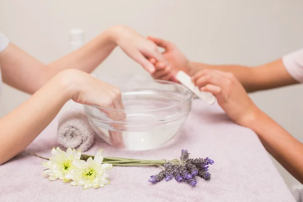 Nail technician giving custome manicure