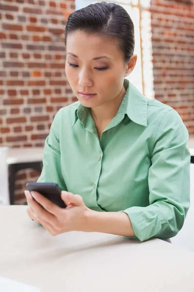 Businesswoman sending  text message