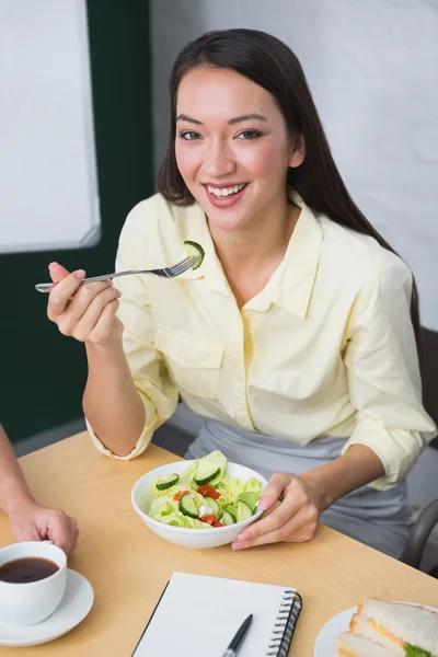 Businesswoman eating healthy salad