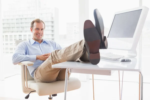 Relaxed businessman with feet up