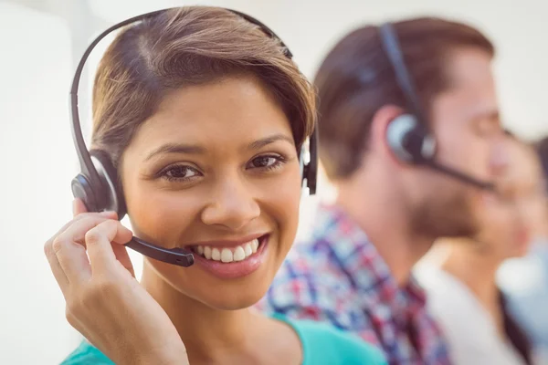 Pretty smiling businesswoman working in a call centre