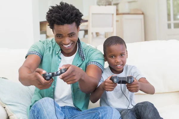 Father and son playing video games together