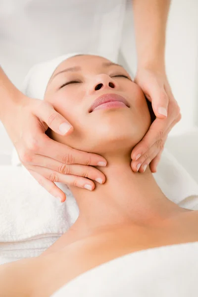 Woman receiving facial massage