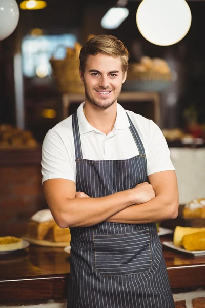 Handsome waiter with arms crossed