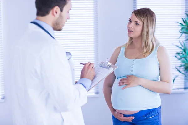 Pregnant patient talking to doctor