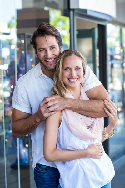 Man putting arm around his girlfriend