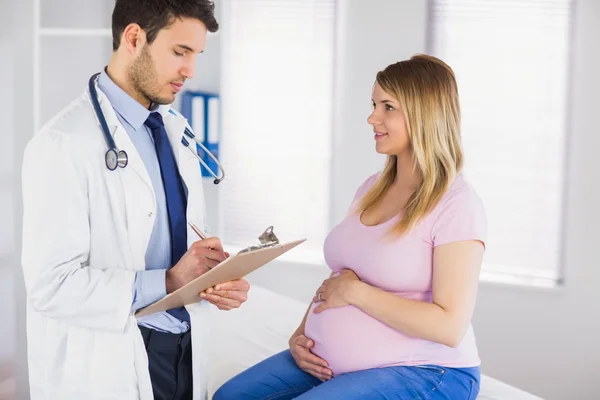 Pregnant patient talking to doctor