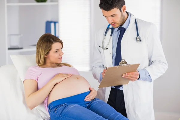 Doctor giving advice to pregnant patient