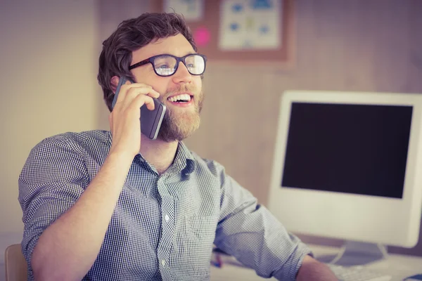 Hipster businessman on the phone at desk
