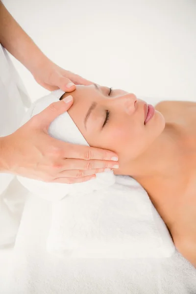 Woman receiving forehead massage