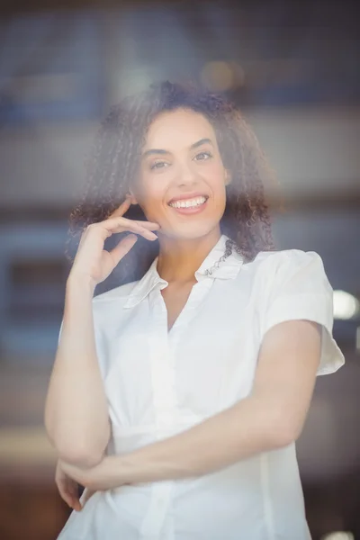 Smiling woman with arms folded