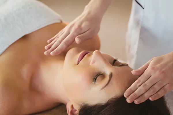 Woman getting herbal compress massage