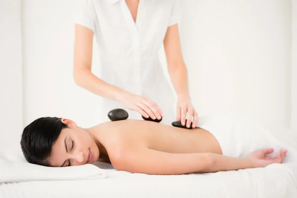 Woman receiving hot stone massage