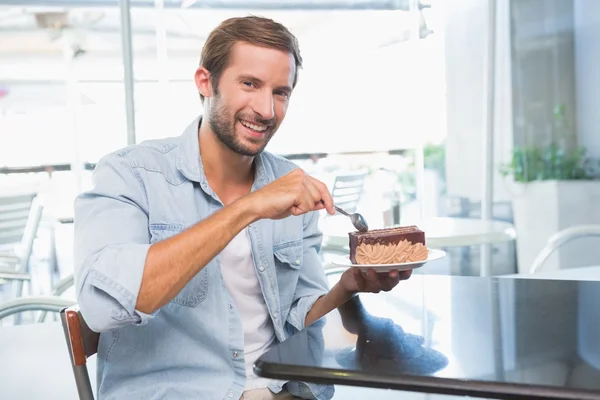 Happy man eating his cake