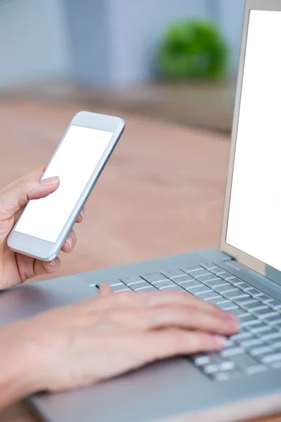 Close up view of hands typing on laptop