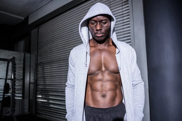 Young Bodybuilder in a hoodie looking at the ground