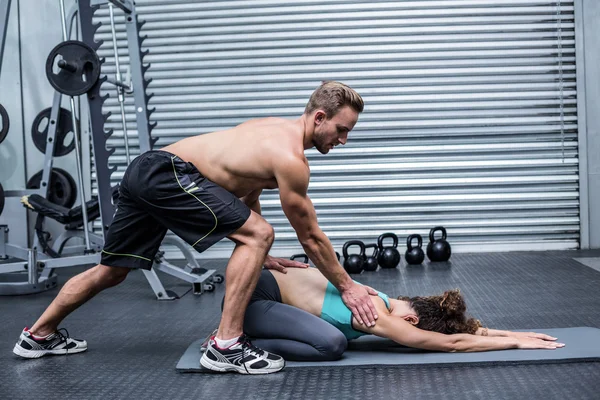 Muscular couple doing a body stretching