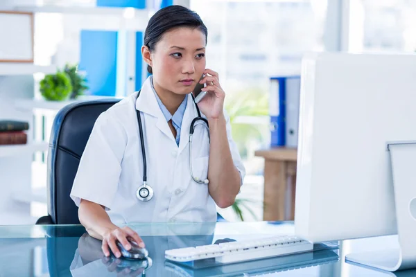 Concentrated doctor having phone call