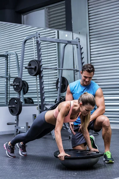 Young bodybuilder training with a young woman