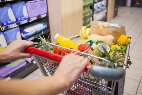 Close up view of woman pushing trolley