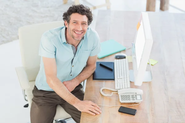 Smiling designer working on his computer