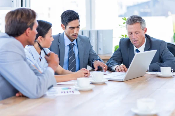 Business people speaking together during meeting